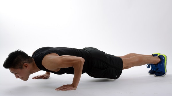 a man doing plank workout exercise at home. This one engages all the muscles in the body