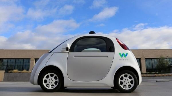 The image shows an autonomous vehicle named Waymo which shows the application of artificial intelligence in self driving cars.