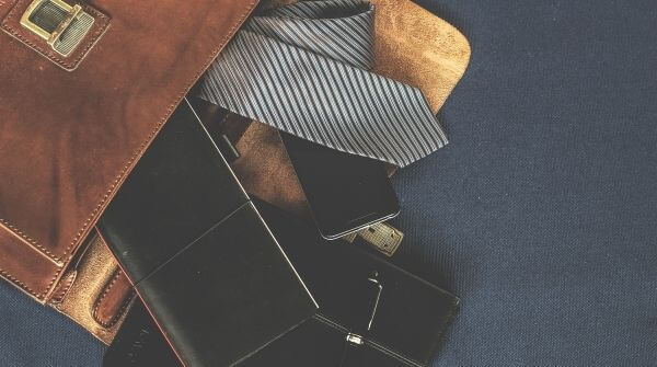Different types of accessories for men that are apt addition for a formal attire. Things like diary, pen, tie, etc.